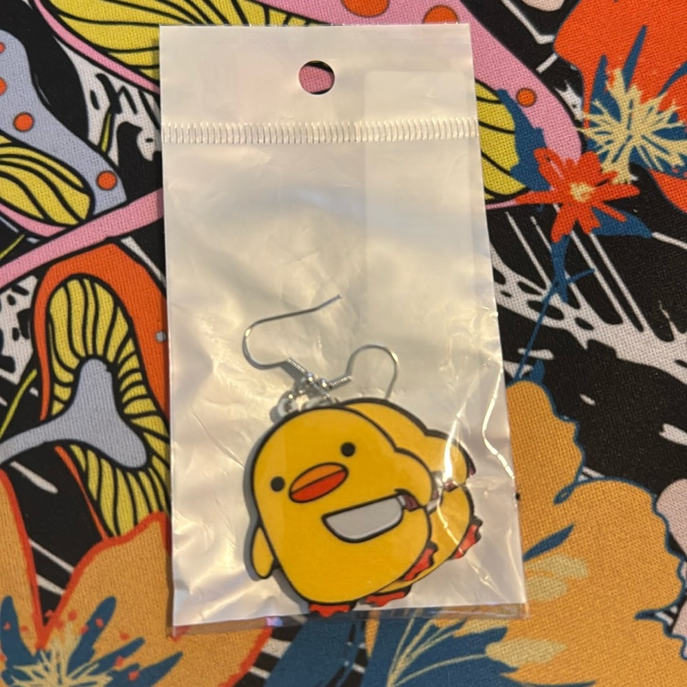 Cute duckling with knife earrings.